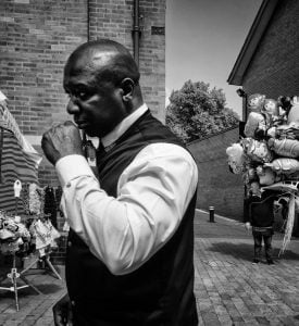 A street photography of a man in a vest.