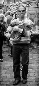 Street photography of a man with a canine companion.