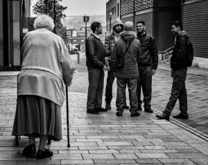 Street photography of people on a sidewalk.