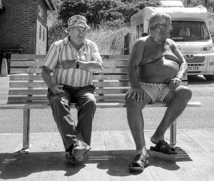 Street photography: Two men sitting on a bench.