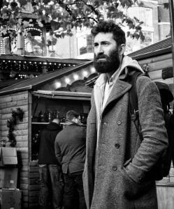 Street photography of a bearded man in a market.