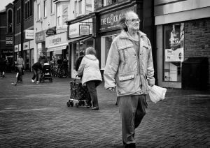 Street photography of a man walking.