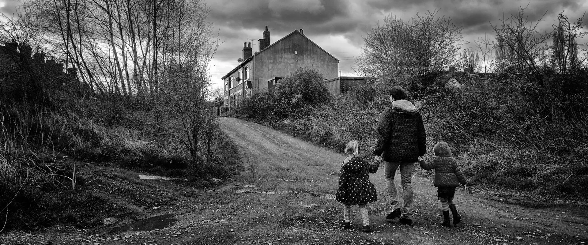 Woman and children walking in old pit village